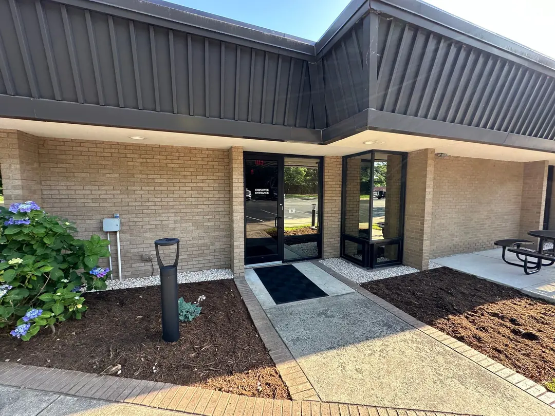 Commercial river rock and landscape bed installation at a Sanford NC business entrance