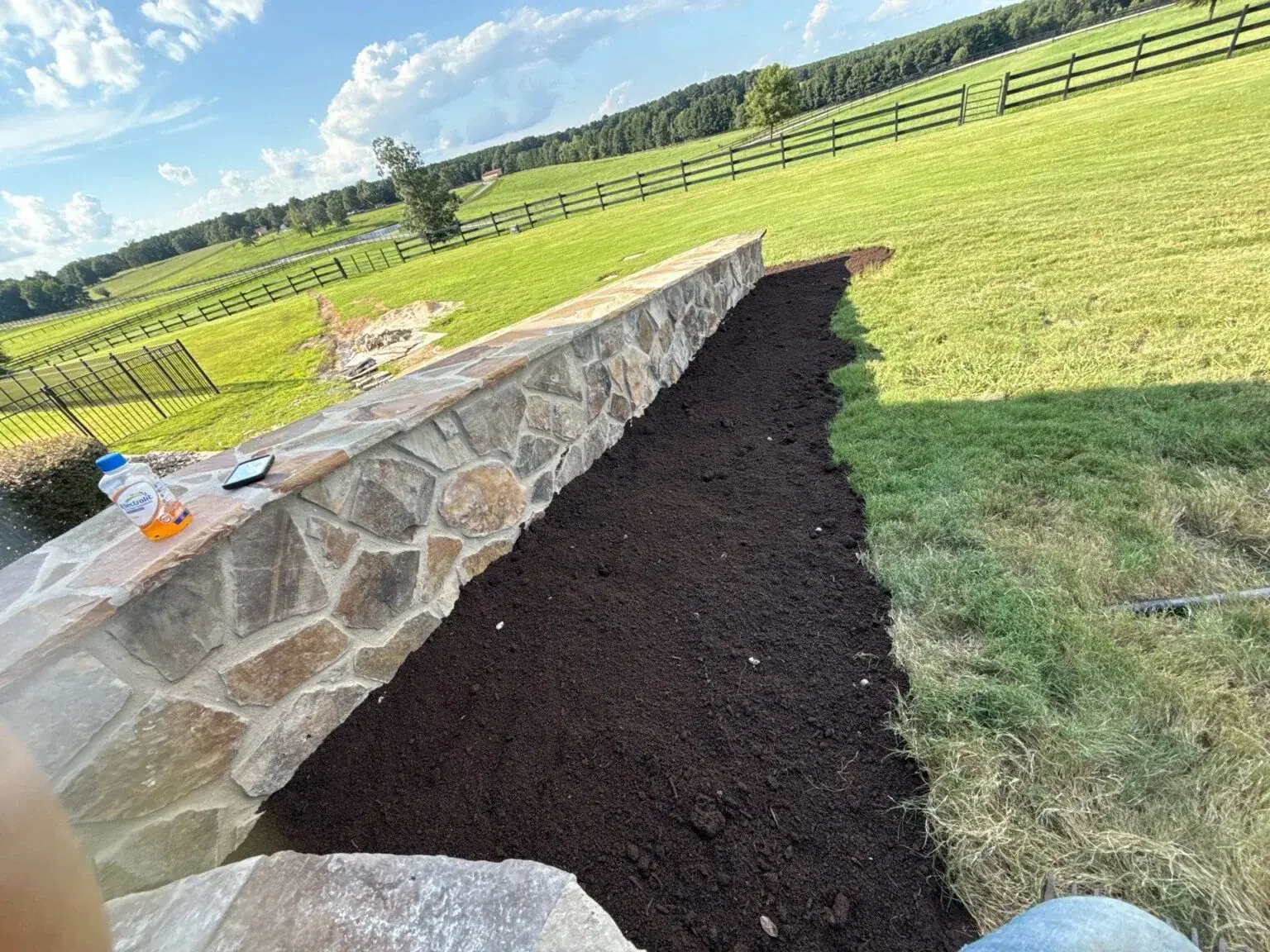 Mulch beds with retaining wall installation